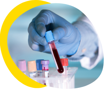 Laboratory technician holding vial of blood